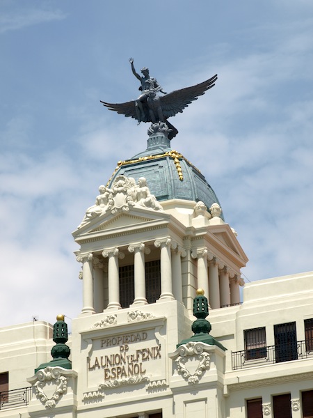 A bare-chested youth riding the Phoenix on top of the Union and Phoenix Insurance building
