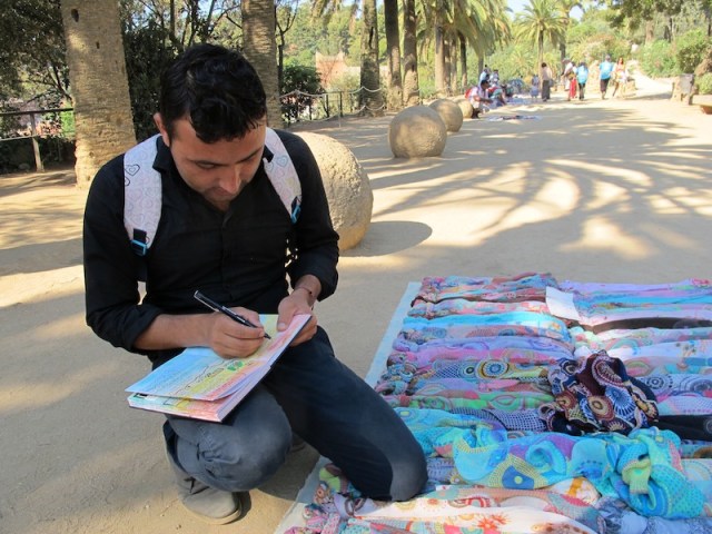 Muhamed signing my concertina book. Bev bought a number of scarves to give away as gifts. 