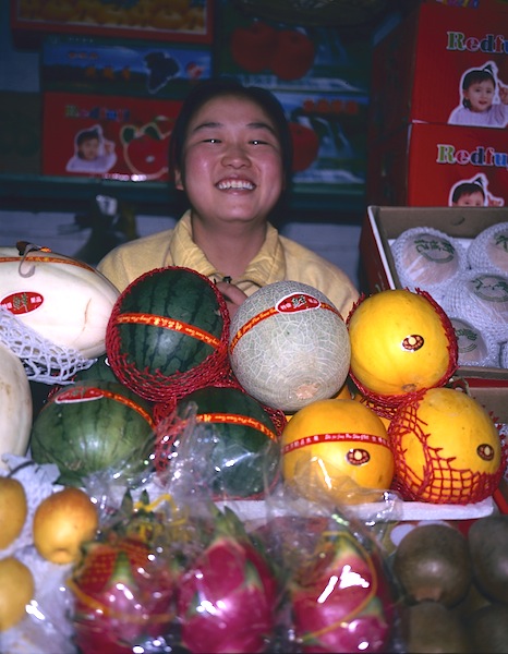 Happy melon seller Urumqi. I was particularly fascinated by the similarity between the shape of the melons and the seller’s face. 