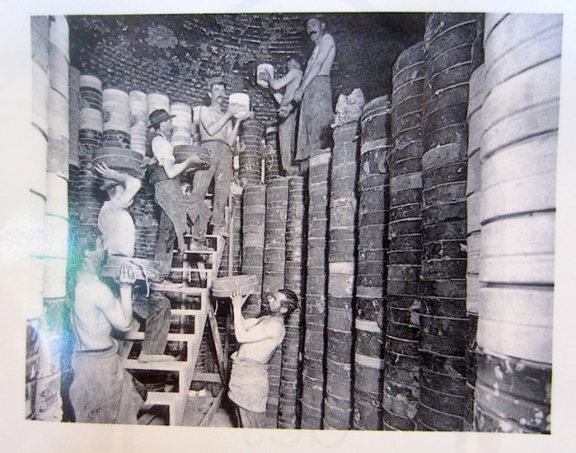 Loading a bottle kiln during the halcyon days of pottery in Limoges..