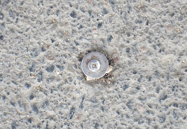 The stainless steel self-tapping screw. I’m guessing this is the historic mark indicating the dead centre of the Eiffel Tower. 